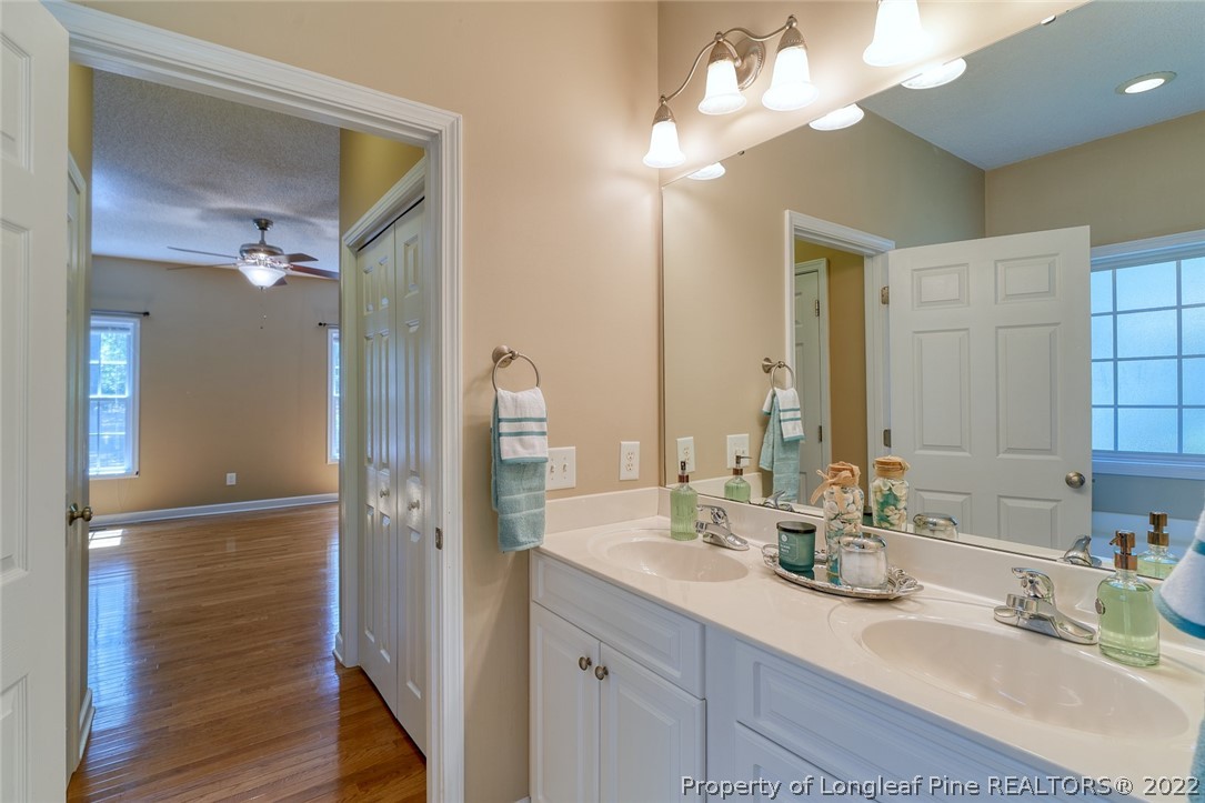 60 Spring Lake Drive Pinehurst, NC 28374 - Photo 24 of 38 a bathroom with a double vanity sink and a mirror