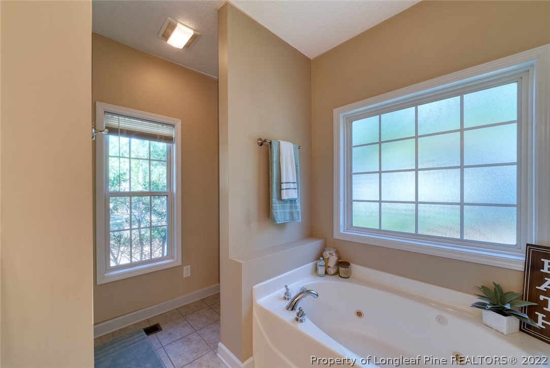 60 Spring Lake Drive Pinehurst, NC 28374 - Photo 26 of 38 a bathroom with a bathtub and window