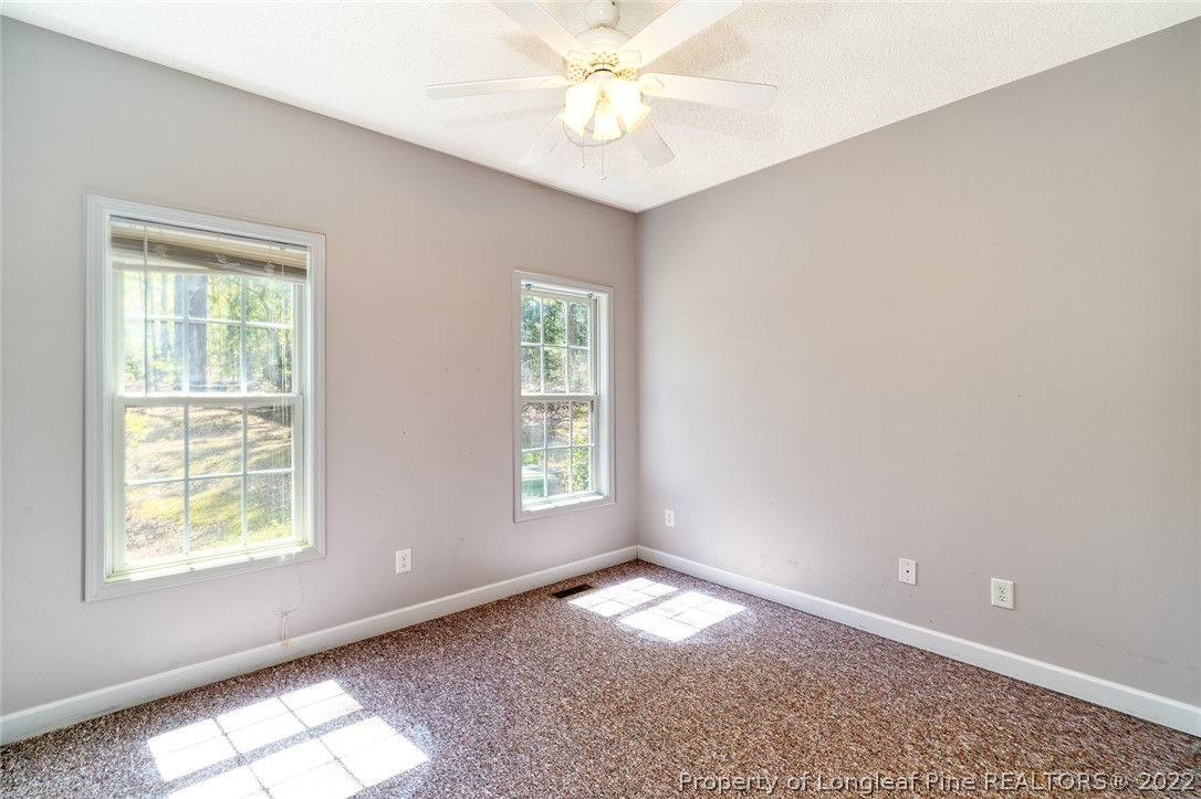 60 Spring Lake Drive Pinehurst, NC 28374 - Photo 27 of 38 an empty room with a window and a fan
