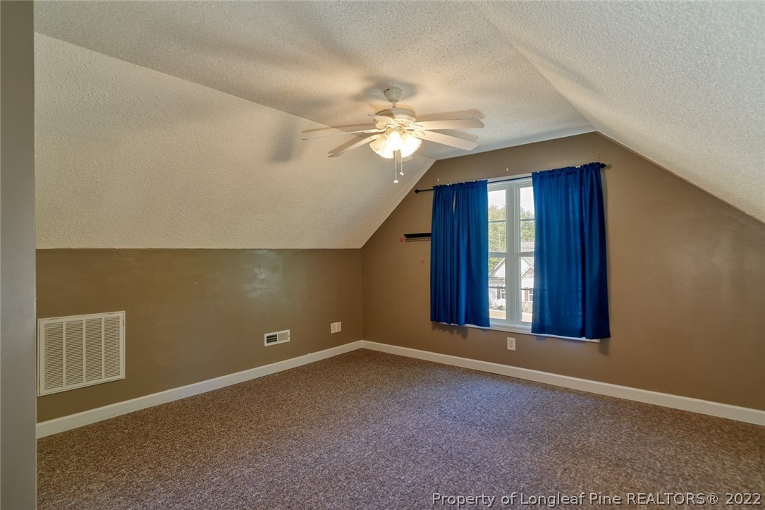 60 Spring Lake Drive Pinehurst, NC 28374 - Photo 29 of 38 a view of an empty room with window and chandelier fan