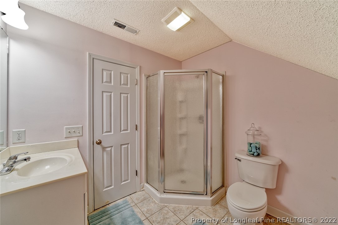 60 Spring Lake Drive Pinehurst, NC 28374 - Photo 32 of 38 a bathroom with a granite countertop sink toilet and shower