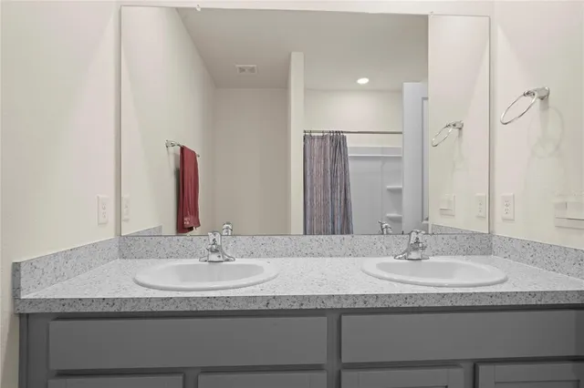 a view of a porch with a table and chairs in front of a door