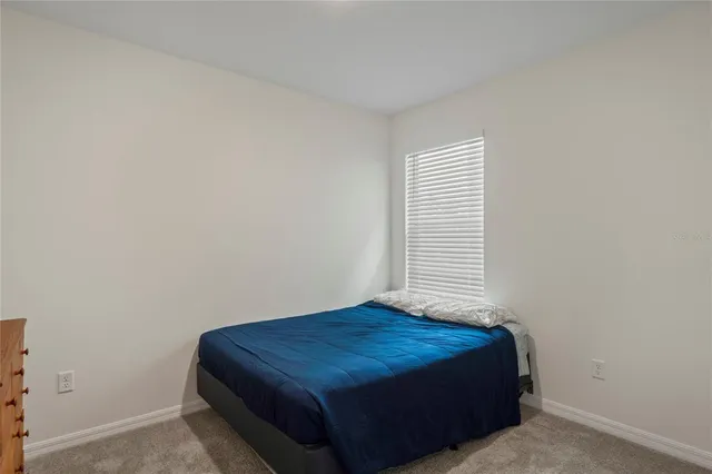 a view of a house with a yard and tree