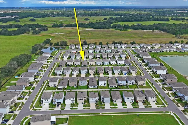 a front view of a house with a garden and plants