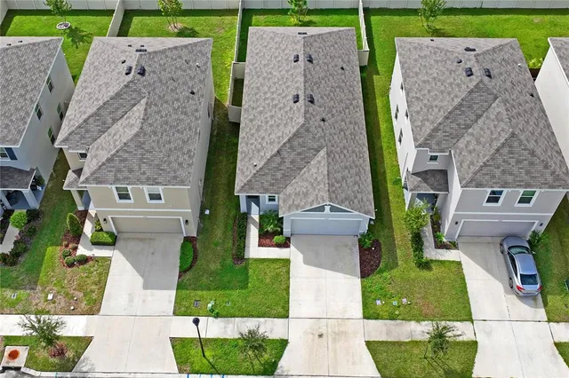 a backyard of a house with table and chairs