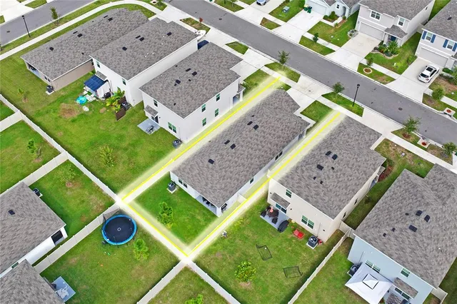 an aerial view of a residential houses with outdoor space