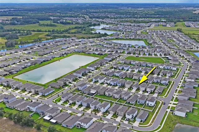an aerial view of a house with a yard and a fountain