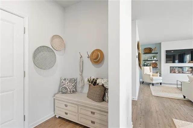 a living room with furniture cabinets and a mirror