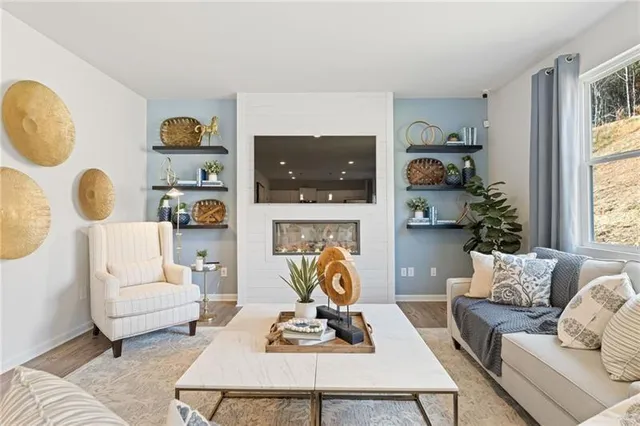 a living room with furniture a flat screen tv and a window