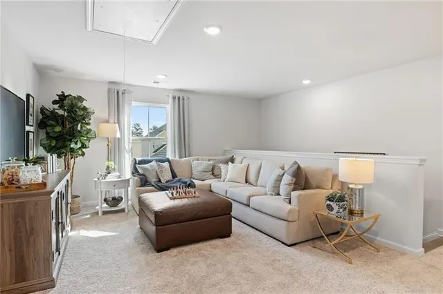 a living room with furniture a table and a potted plant