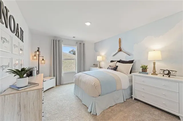 a bedroom with a bed and a potted plant