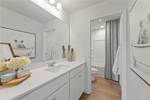 a bathroom with a sink and mirror with toilet