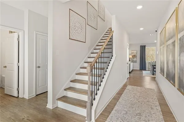 a view of a hallway with wooden floor and entryway