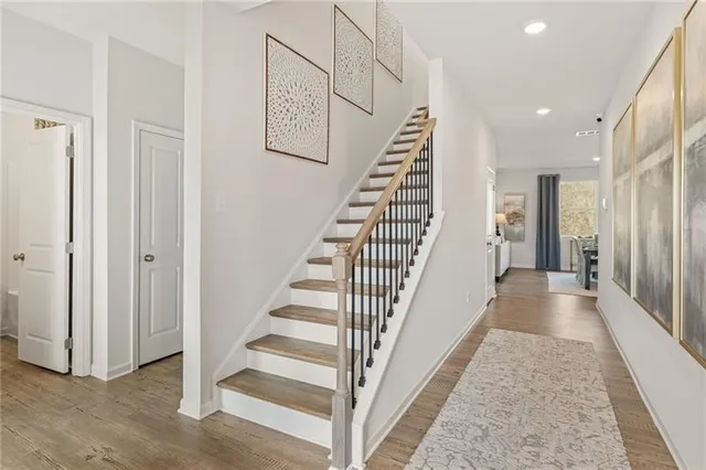 a view of a hallway with wooden floor and entryway