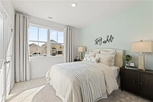 a bedroom with a large bed and a window