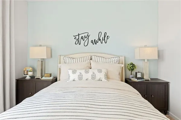 a bedroom with a bed and a night stand