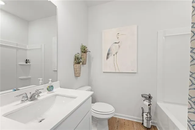 a bathroom with a sink mirror and toilet
