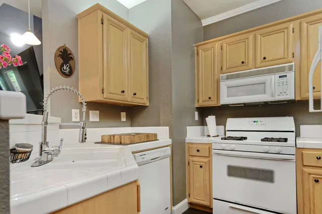 a kitchen with cabinets appliances and a sink