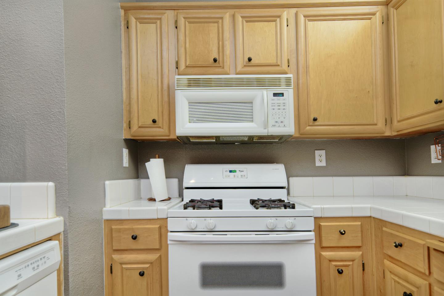 1021 Chagall Way San Jose, CA 95138 - Photo 12 of 25 a kitchen with granite countertop white cabinets and white appliances