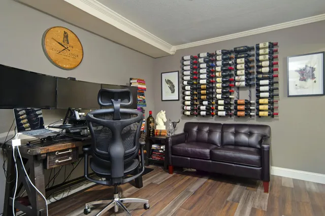 a view of a workspace with furniture and wooden floor