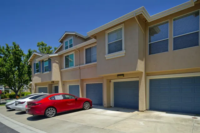 a red car parked in front of a building