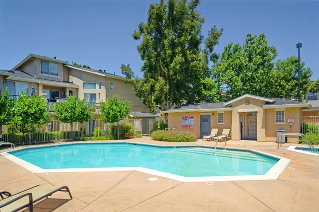 a view of a house with a swimming pool and a yard