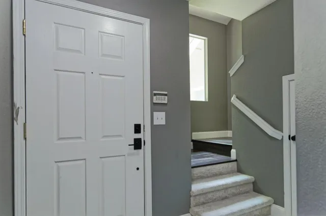a view of entryway and hall with wooden floor