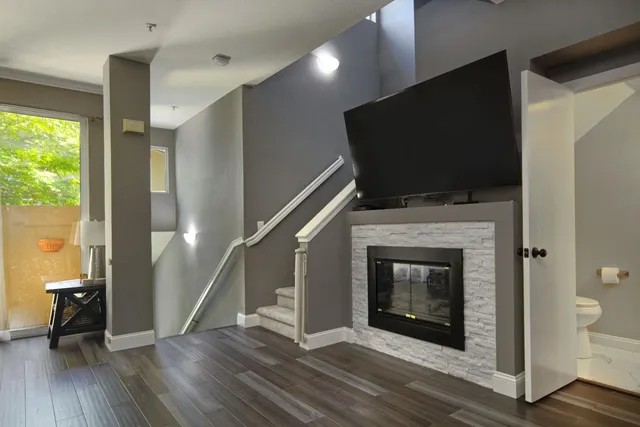 a living room with a fireplace and a flat screen tv