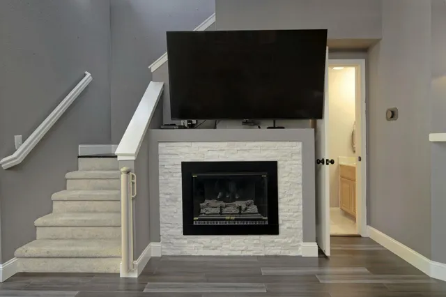 a living room with a fireplace and a flat screen tv