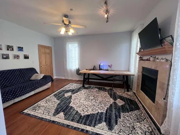 a living room with furniture and a fireplace