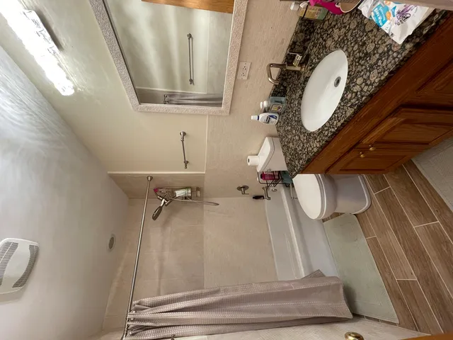 a living room with furniture and a painting on the wall