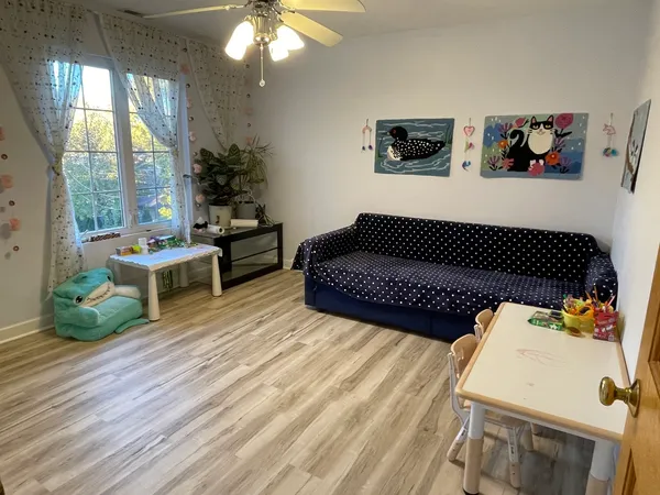 a living room with furniture and a painting on the wall