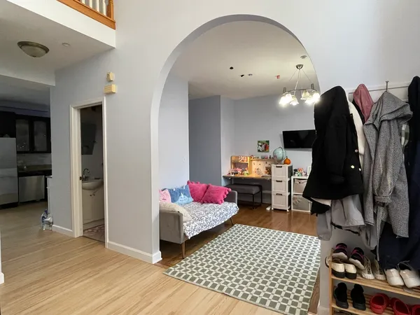a bedroom with furniture and a wooden floor