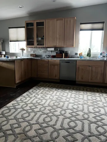 a kitchen with a sink a stove a microwave and cabinets