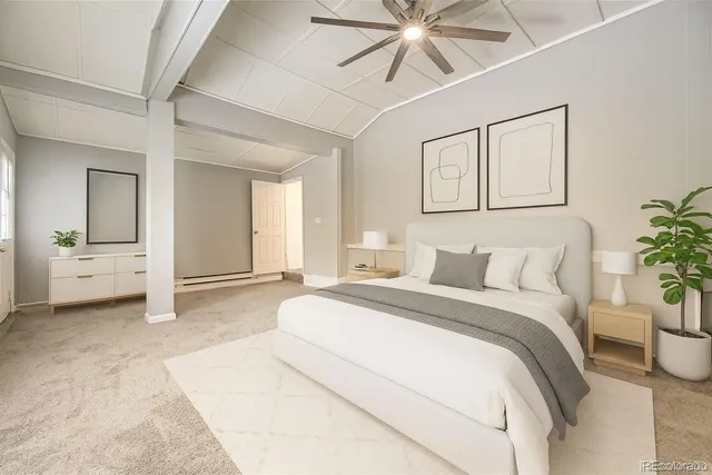 a spacious bedroom with a large bed a chandelier and a potted plant