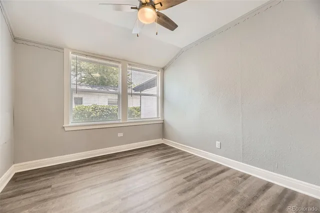 a view of wooden floor and windows in a room