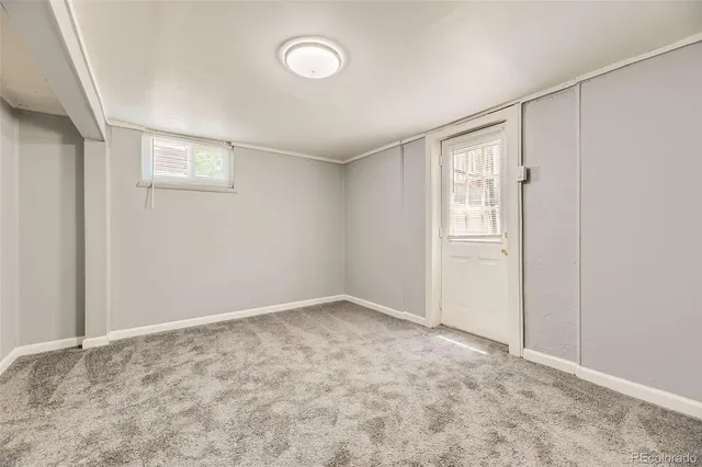 an empty room with windows and closet