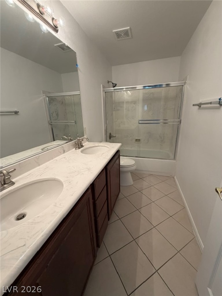 3862 Landing Ridge Place Las Vegas, NV 89135 - Photo 22 of 26 A clean, modern bathroom offers a dual vanity, sleek shower, and tiled flooring.