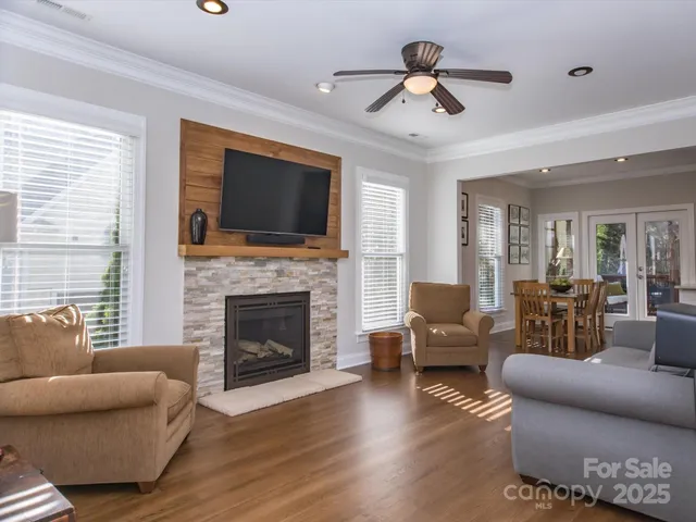 a living room with furniture a fireplace and a flat screen tv
