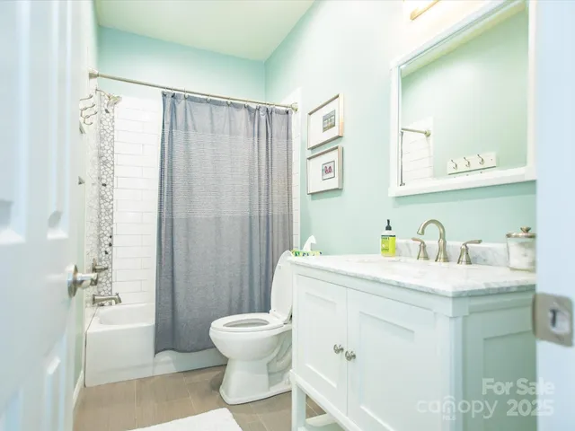 a spacious bathroom with a granite countertop sink toilet and shower