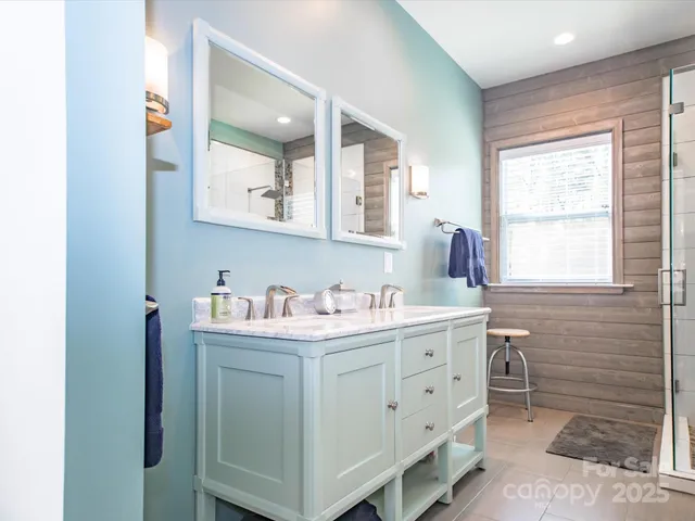 a bathroom with a window sink and mirror