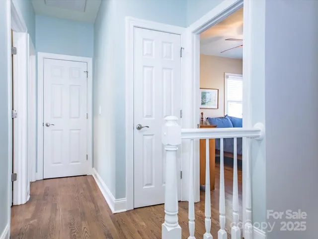 a view of a hallway with wooden floor and entryway