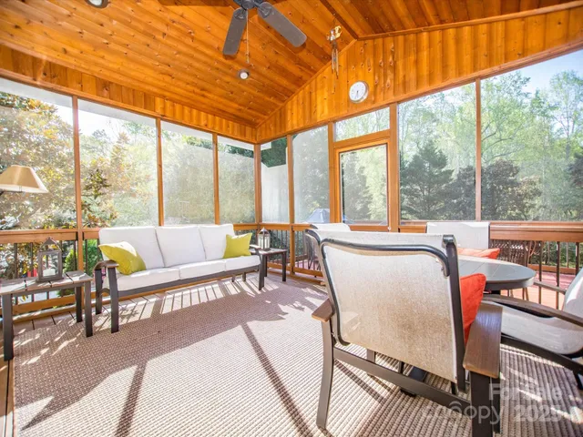 a living room with furniture a rug and a large window