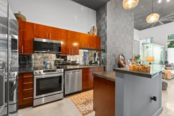 a kitchen with stainless steel appliances granite countertop a stove and a sink