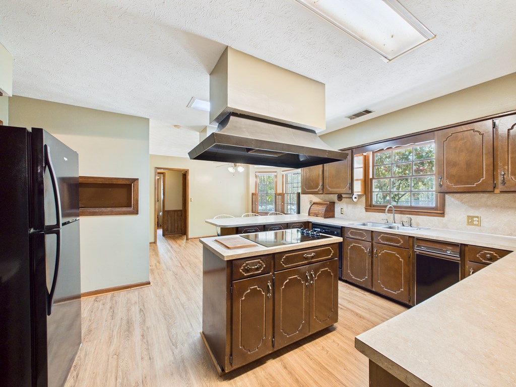 233 Ga Highway Fortson, GA 31808 - Photo 20 of 74 a kitchen with stainless steel appliances granite countertop a stove a sink and a refrigerator