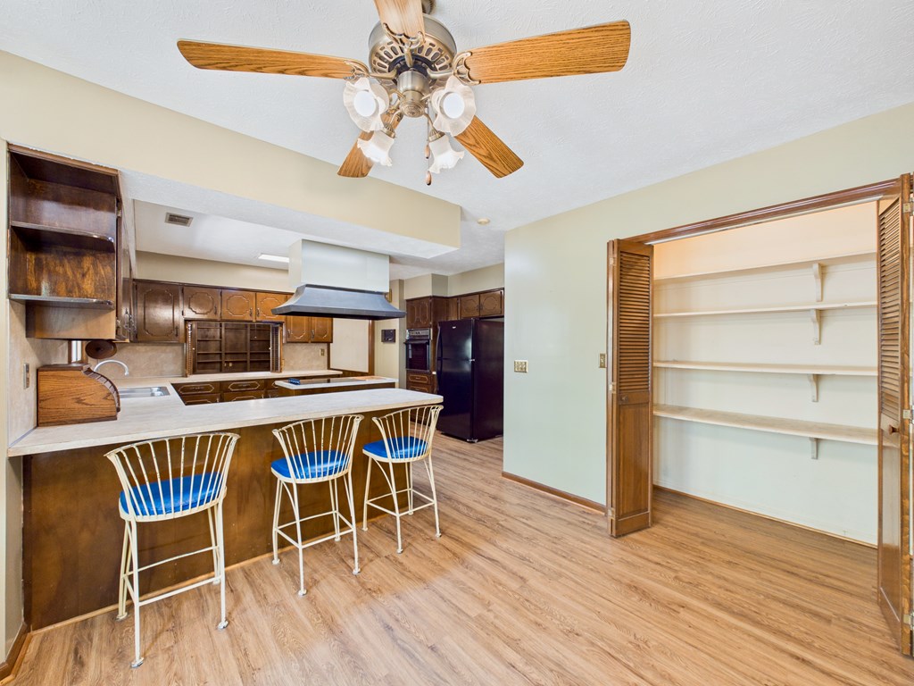 233 Ga Highway Fortson, GA 31808 - Photo 24 of 74 a dining room with wooden floor a chandelier a glass table and chairs