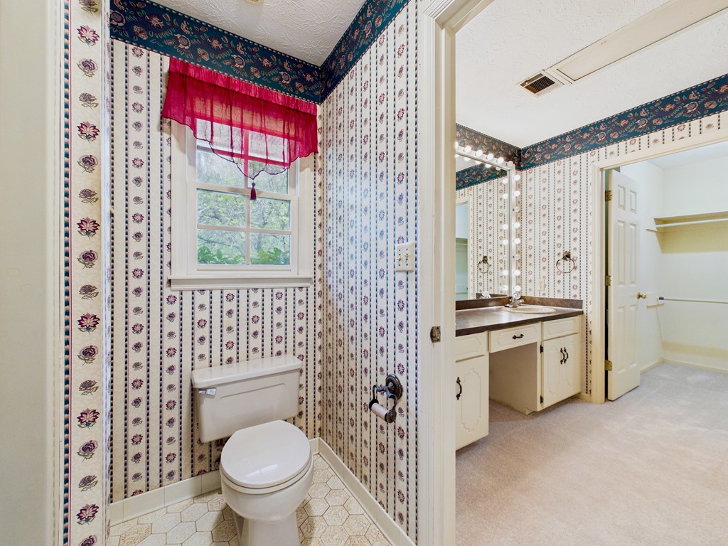 233 Ga Highway Fortson, GA 31808 - Photo 34 of 74 a spacious bathroom with a granite countertop toilet a sink and a large mirror