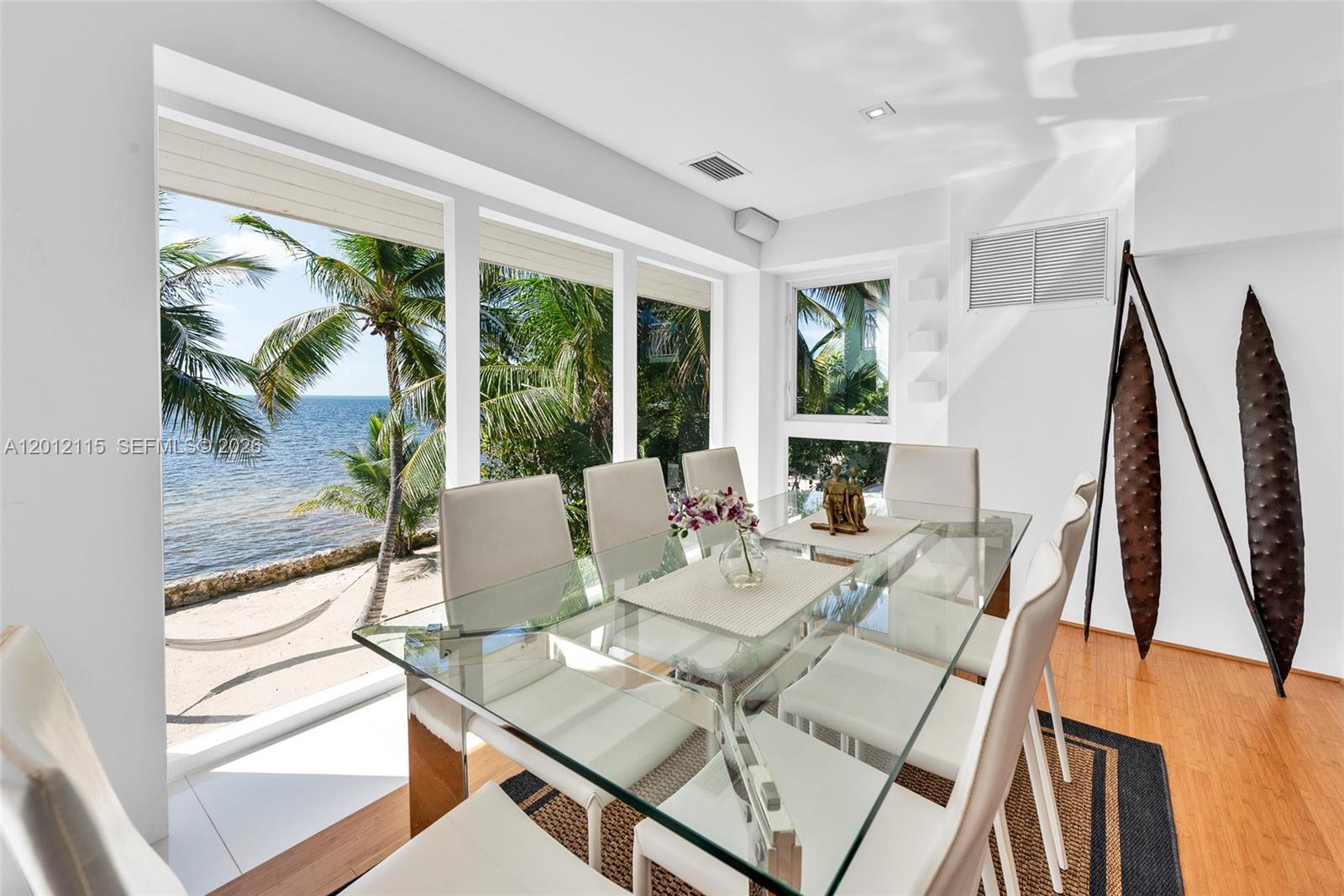 60 Ocean Front Drive Key Largo, FL 33037 - Photo 48 of 85 a view of a dining room with furniture window and outside view