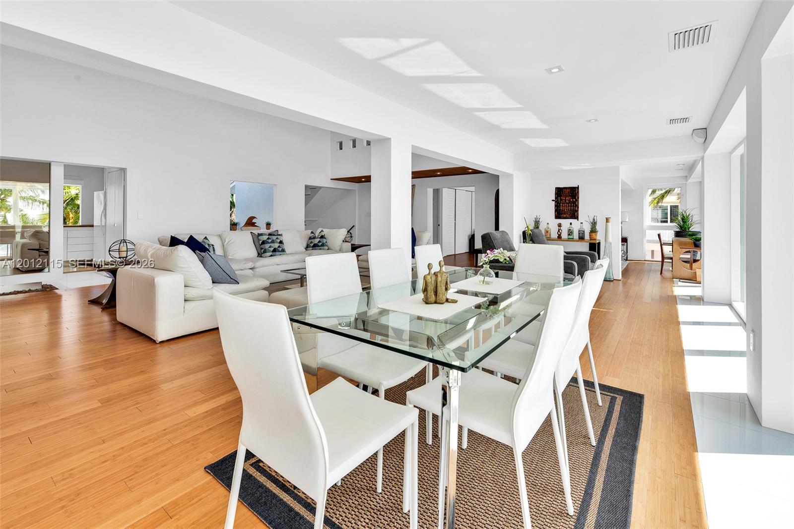 60 Ocean Front Drive Key Largo, FL 33037 - Photo 51 of 85 a view of a dining room with furniture and wooden floor