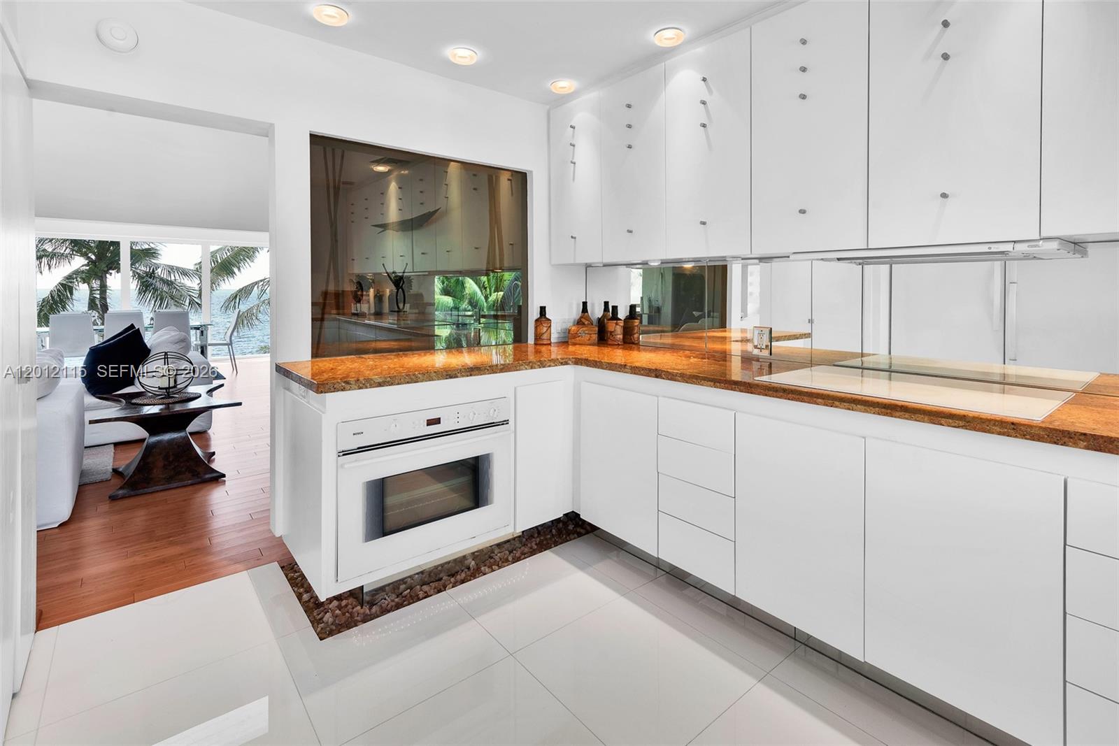 60 Ocean Front Drive Key Largo, FL 33037 - Photo 58 of 85 a kitchen with stainless steel appliances granite countertop a stove a sink and white cabinets